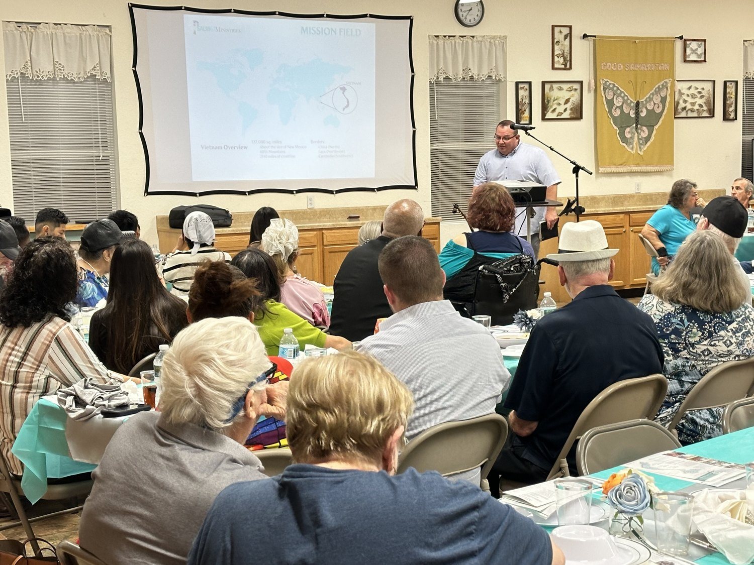 Guests listening to a presentation about the Vietnam mission field