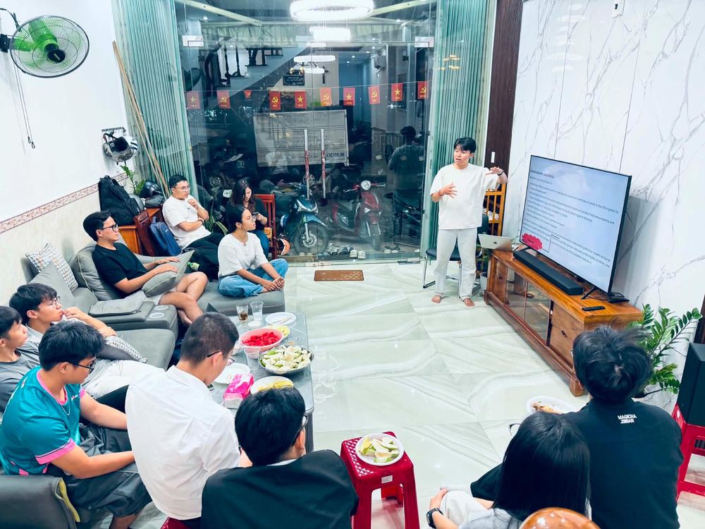 Young adults listening to a presentation at the ministry house