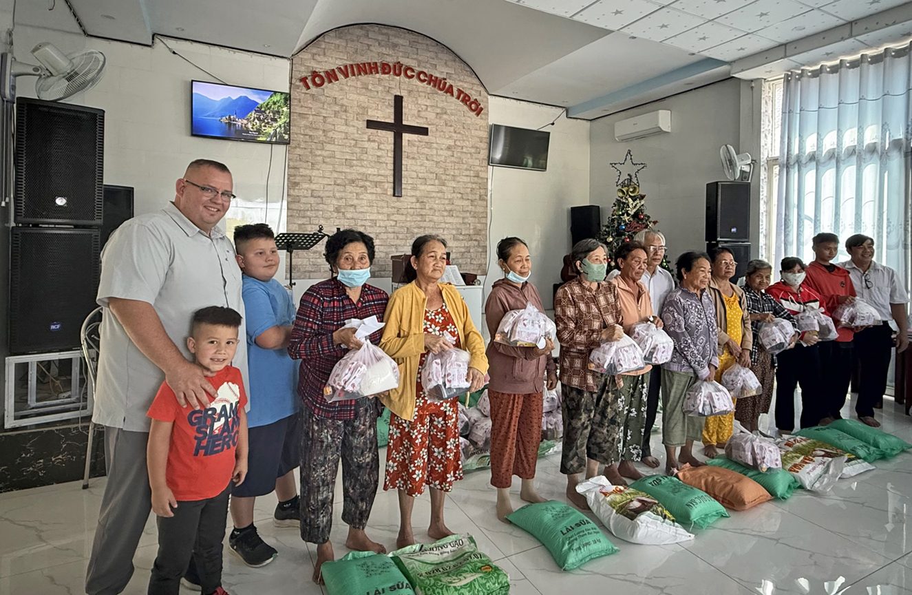 Widows and families receiving bags of food at a partner church in Vietnam