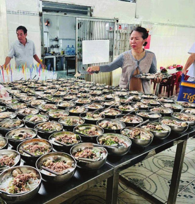Staff serving meals to the children at the Care Center