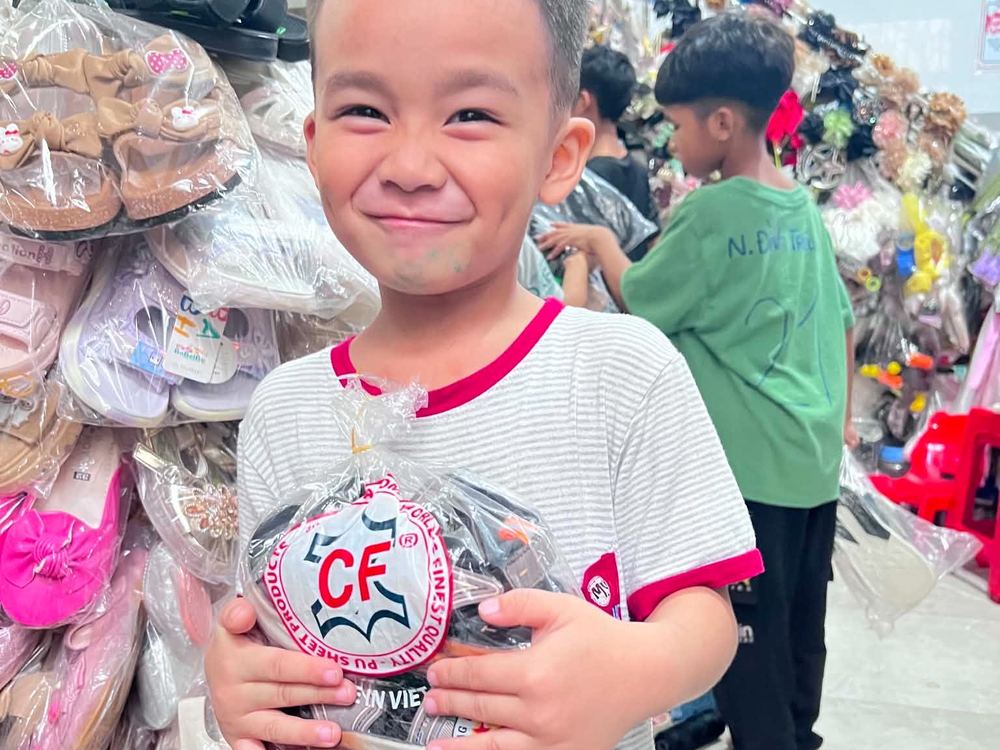 A smiling boy with his new school supplies