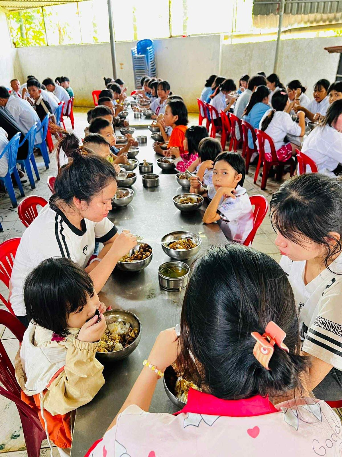 Children sharing a meal at long tables