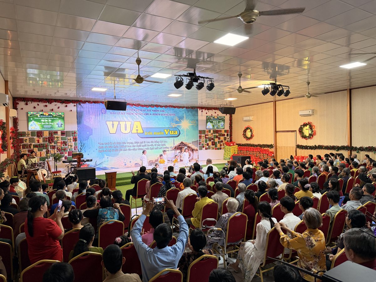 A full church watching children perform a nativity play at a Christmas outreach