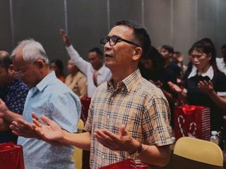 Pastors with hands open in prayer