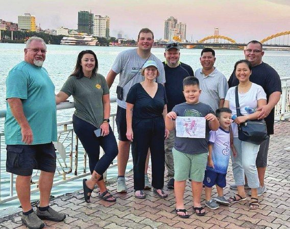 A visiting mission team with the Miles family on a riverfront in Vietnam