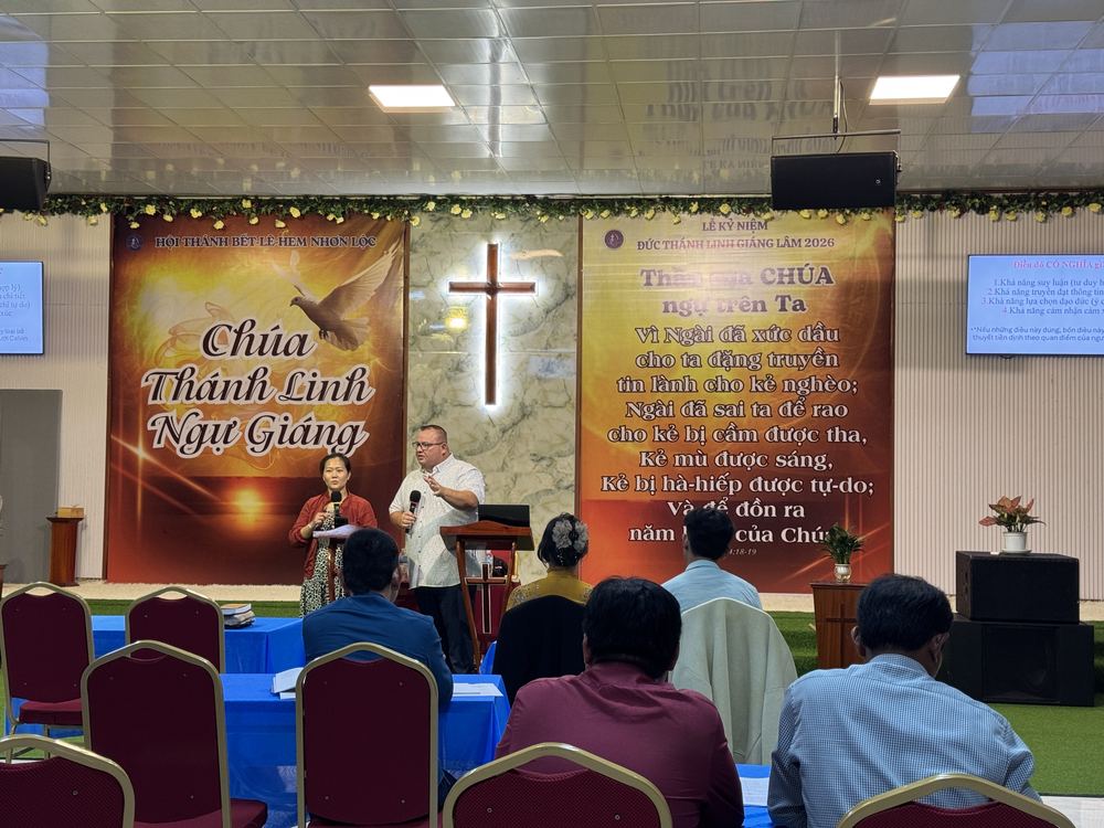 Pastors listening to teaching in front of the church platform