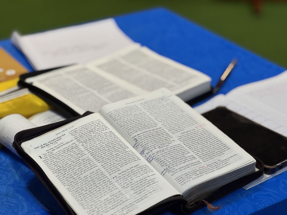 Open Bibles and notebooks on a classroom table