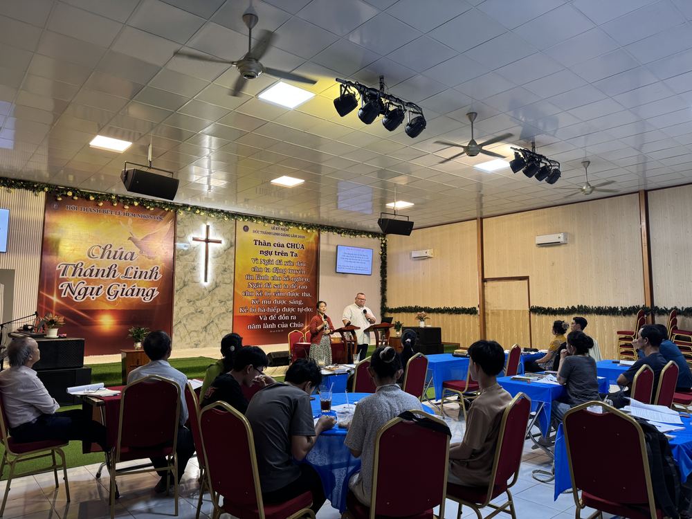 Pastors and leaders seated at their tables during a session