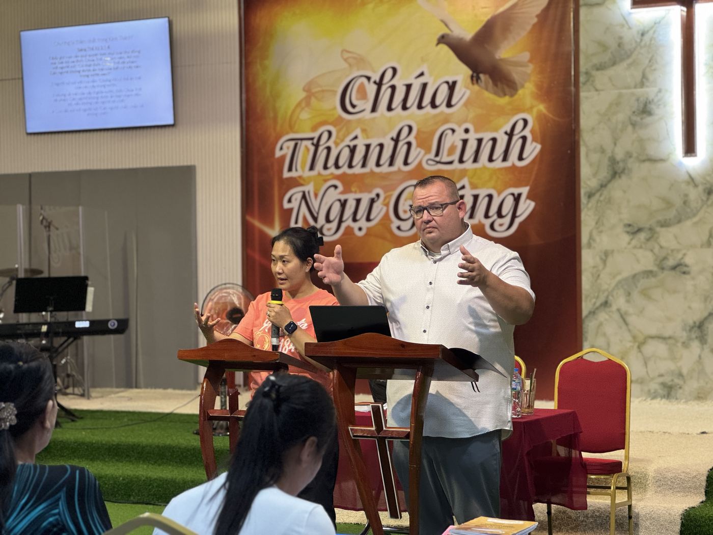 Dr. Shaun Miles teaching pastors and leaders in the Mekong Delta, with a translator beside him