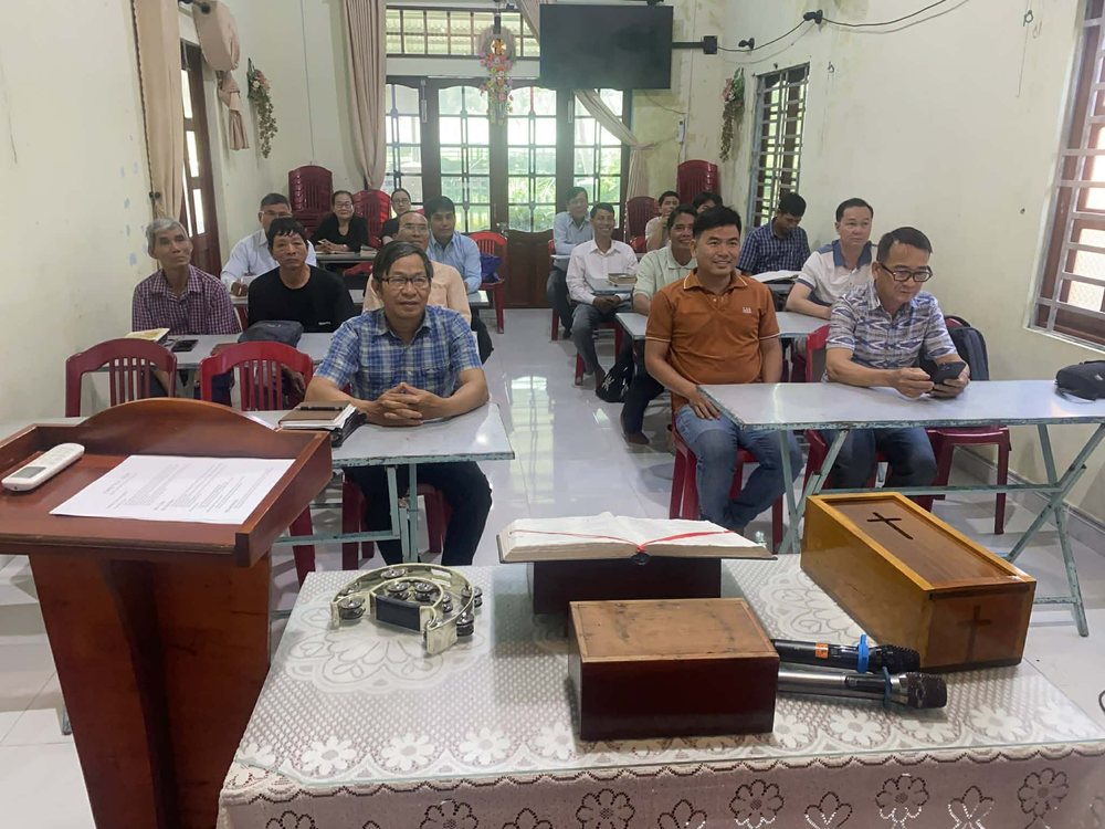 Pastors and leaders seated at their desks in a training class in Vietnam