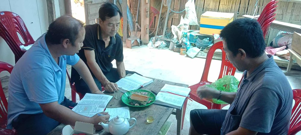 Three men studying their Bibles together around a table