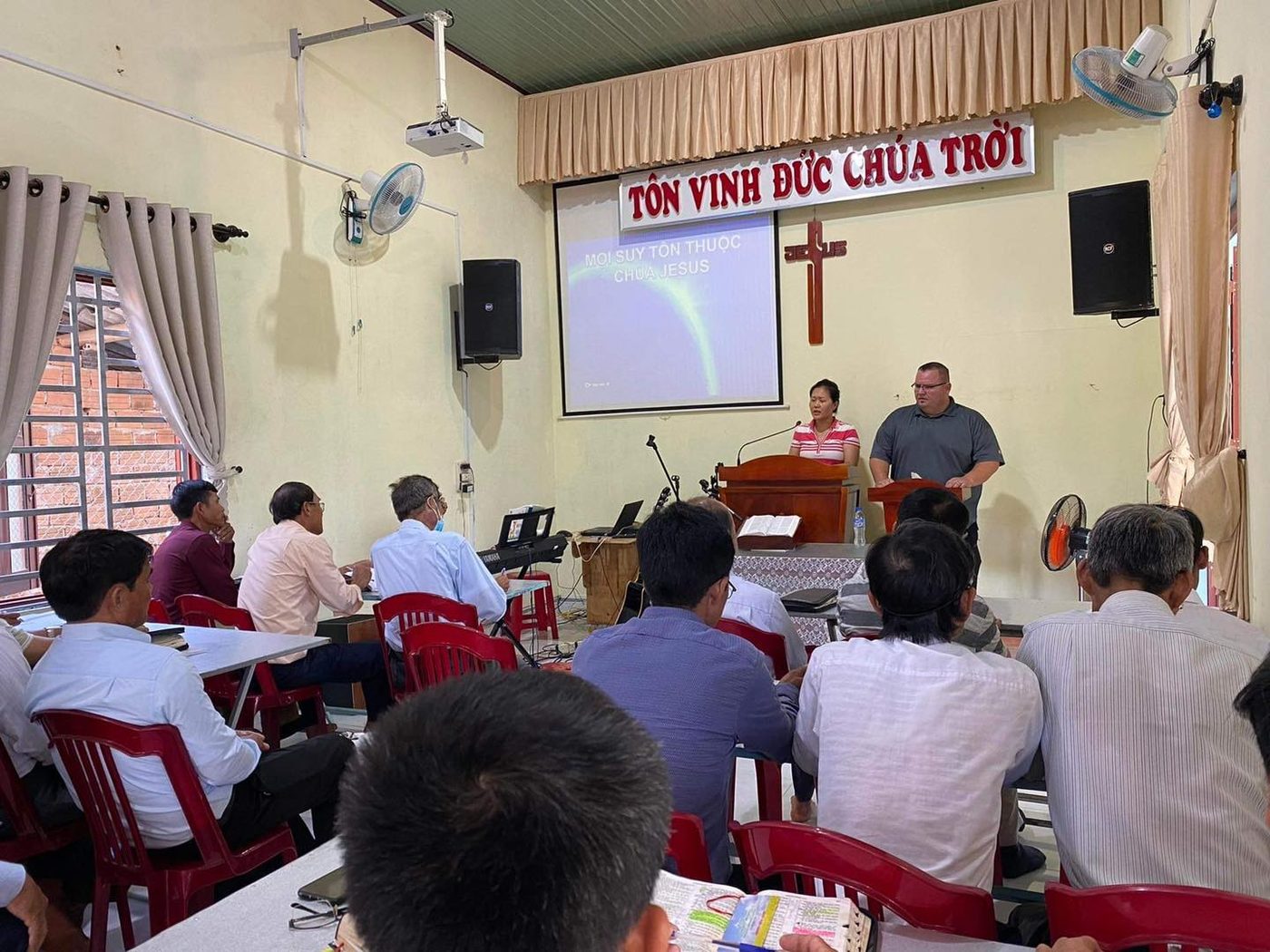 Dr. Shaun Miles teaching pastors in a church classroom in Vietnam, with a translator beside him