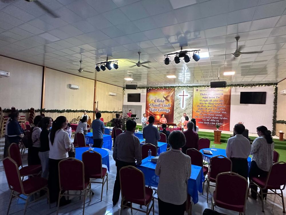 Worshipers standing during the Sunday service