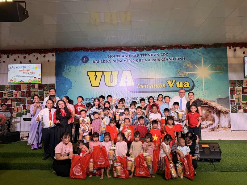 Children with Christmas gifts on a church stage